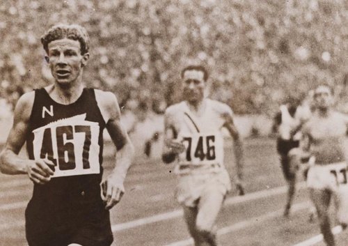 runner Jack Lovelock is leading a race against 3 other runners at the Berlin Olympic Games in 1936.