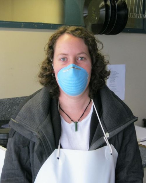 Disc preservationist wearing protective clothing during the disc cleaning process..