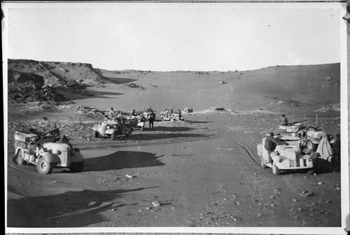 Vehicles parked in a group in the desert