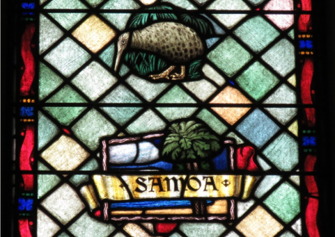 A stained glass window window depicting a kiwi and a tree with the word 'Samoa' in front of it.