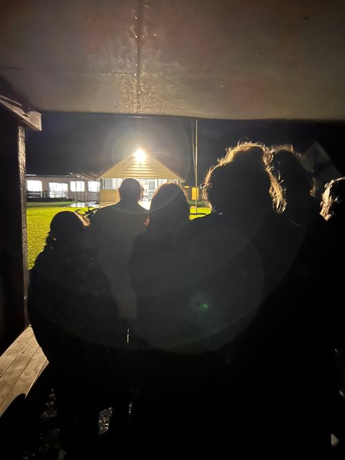 People entering a marae in the dark